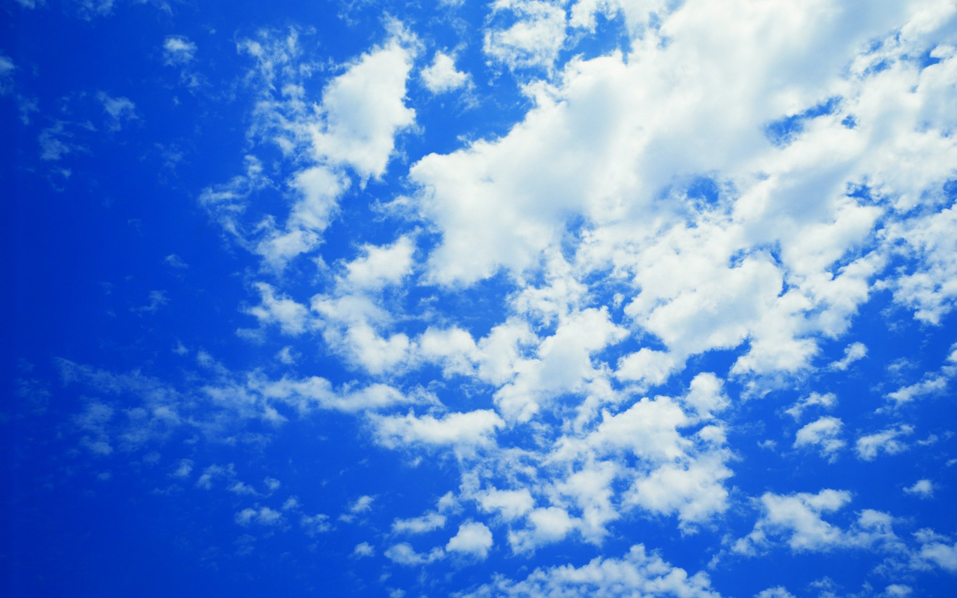 2K Quad HD PC desktop wallpaper/background: vivid blue sky dotted with soft white clouds, a tranquil nature cloud scene.