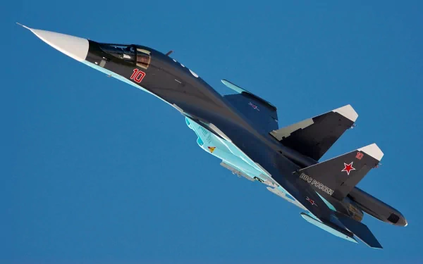 HD desktop wallpaper featuring a military Sukhoi Su-34 fighter jet soaring against a clear blue sky.