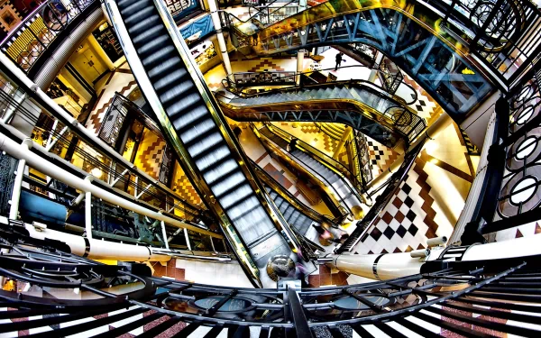 HD desktop wallpaper showcasing a vibrant, man-made monument mall with multiple escalators and intricate architectural details captured from an overhead perspective.