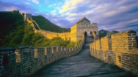 A breathtaking view of the Great Wall of China, capturing its majestic structure and surrounding landscape under a vibrant sky. An ideal HD wallpaper to enhance your desktop background.