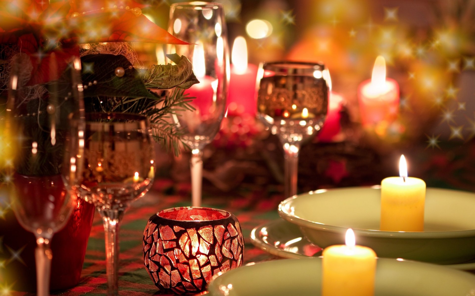 HD PC desktop wallpaper featuring a warm, festive Christmas holiday table setting with glowing candles, sparkling glassware, and cozy ambient lighting.