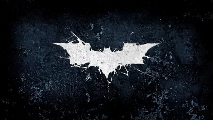 A striking Batman symbol from The Dark Knight Rises displayed against a textured dark background, serving as a bold HD desktop wallpaper and background.