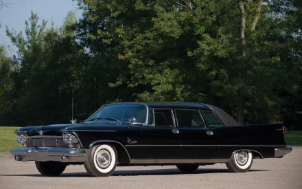 Black 1958 Chrysler Imperial Crown sedan parked before leafy trees, side view — HD PC desktop wallpaper/background.