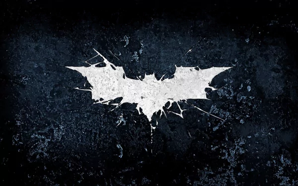 A striking Batman symbol from The Dark Knight Rises displayed against a textured dark background, serving as a bold HD desktop wallpaper and background.