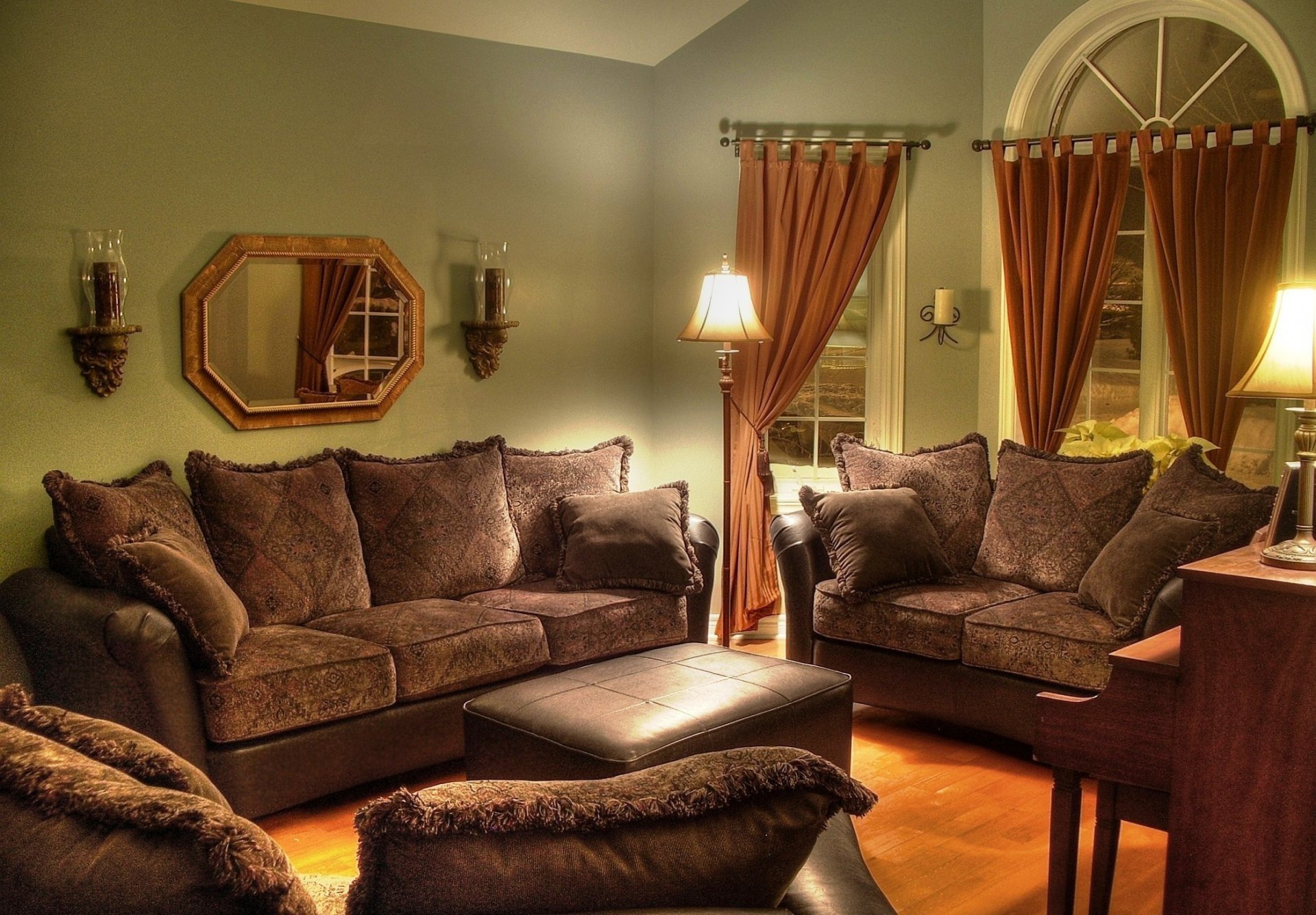 Cozy living room with plush furniture, warm lighting, and elegant curtains, captured in an HD PC desktop wallpaper featuring a man-made indoor setting.
