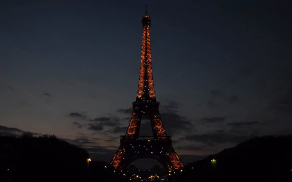 Eiffel Tower illuminated at night in Paris, France — man-made landmark captured as a 4K Ultra HD PC desktop wallpaper and background.
