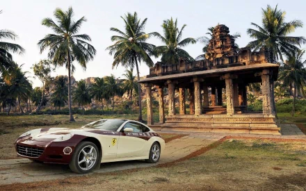 HD PC desktop wallpaper featuring a Ferrari 612 Scaglietti parked near an ancient stone temple surrounded by palm trees.