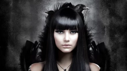 A striking portrait of a model with long black hair and an ethereal expression, surrounded by dark feathers and crows, creating an intriguing HD desktop wallpaper.