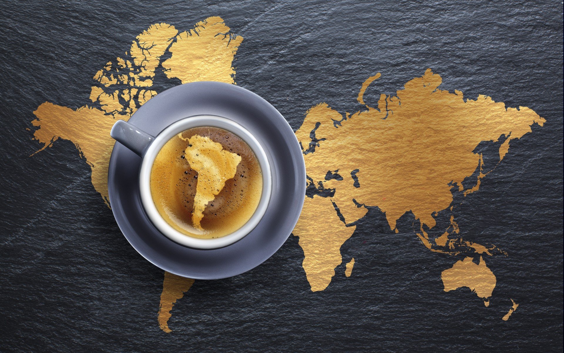 HD PC desktop wallpaper showing a top-down coffee cup with crema echoing continents over a gold world map on a dark slate background — food, coffee