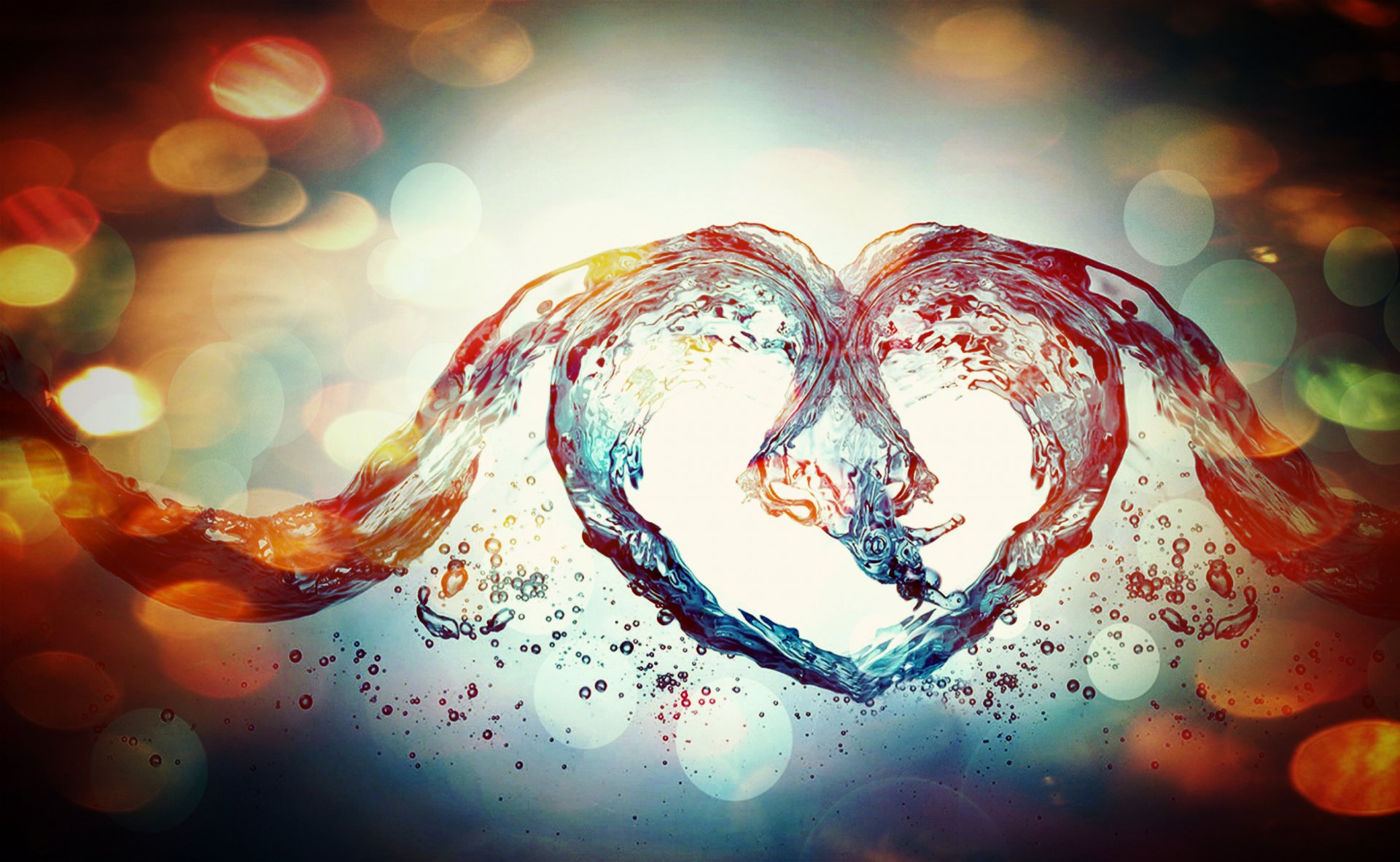 Artistic heart formed by twin water splashes against warm bokeh lights — vibrant 2K Quad HD PC desktop wallpaper and background.