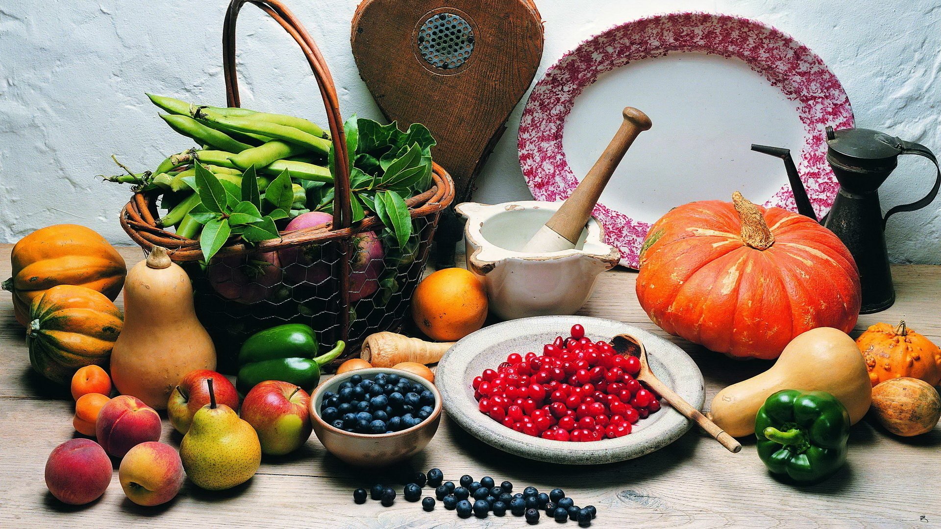 HD PC desktop wallpaper and background: colorful still-life of assorted fruits and vegetables on a rustic table—bowl of red berries, blueberries, pumpkins, pears and vintage kitchenware.