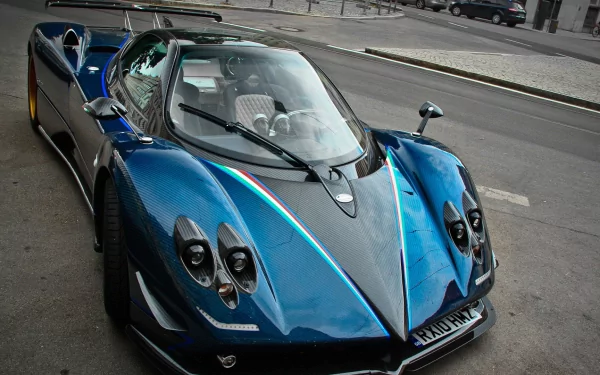 A stunning Pagani Zonda parked on the street, showcasing its sleek design and vibrant blue color, serves as an impressive HD desktop wallpaper and background.