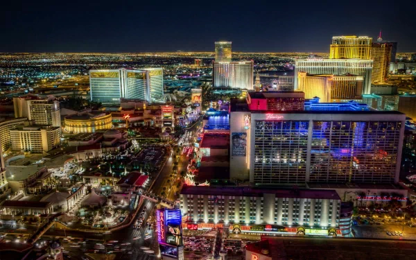 A stunning HD wallpaper showcasing the vibrant lights of Las Vegas at night, highlighting the city's iconic man-made architecture and bustling atmosphere.