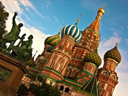 HD desktop wallpaper showcasing the vibrant domes of Saint Basil's Cathedral under a bright sky, highlighting its religious and architectural significance.