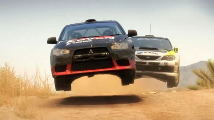 HD PC desktop wallpaper/background of two rallye vehicles airborne over a dusty dirt track, the front car mid-jump with a second car close behind.