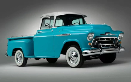HD desktop wallpaper featuring a classic turquoise Chevrolet 3100 vintage pickup truck against a gray background.