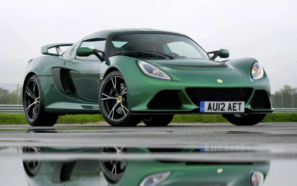 A sleek green Lotus Exige sports car with black accents, showcased on a wet surface reflecting the vehicle, captured as an HD desktop wallpaper.