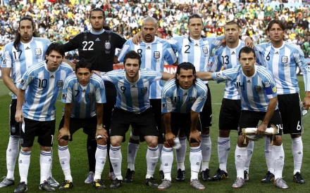 Argentina National Football Team stands proudly for a group photo, showcasing their iconic blue and white striped jerseys, ready for a match in this HD desktop wallpaper.