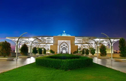 4K Ultra HD desktop wallpaper showcasing the illuminated Iron Mosque at dusk, blending modern architecture with religious design under a clear blue sky.
