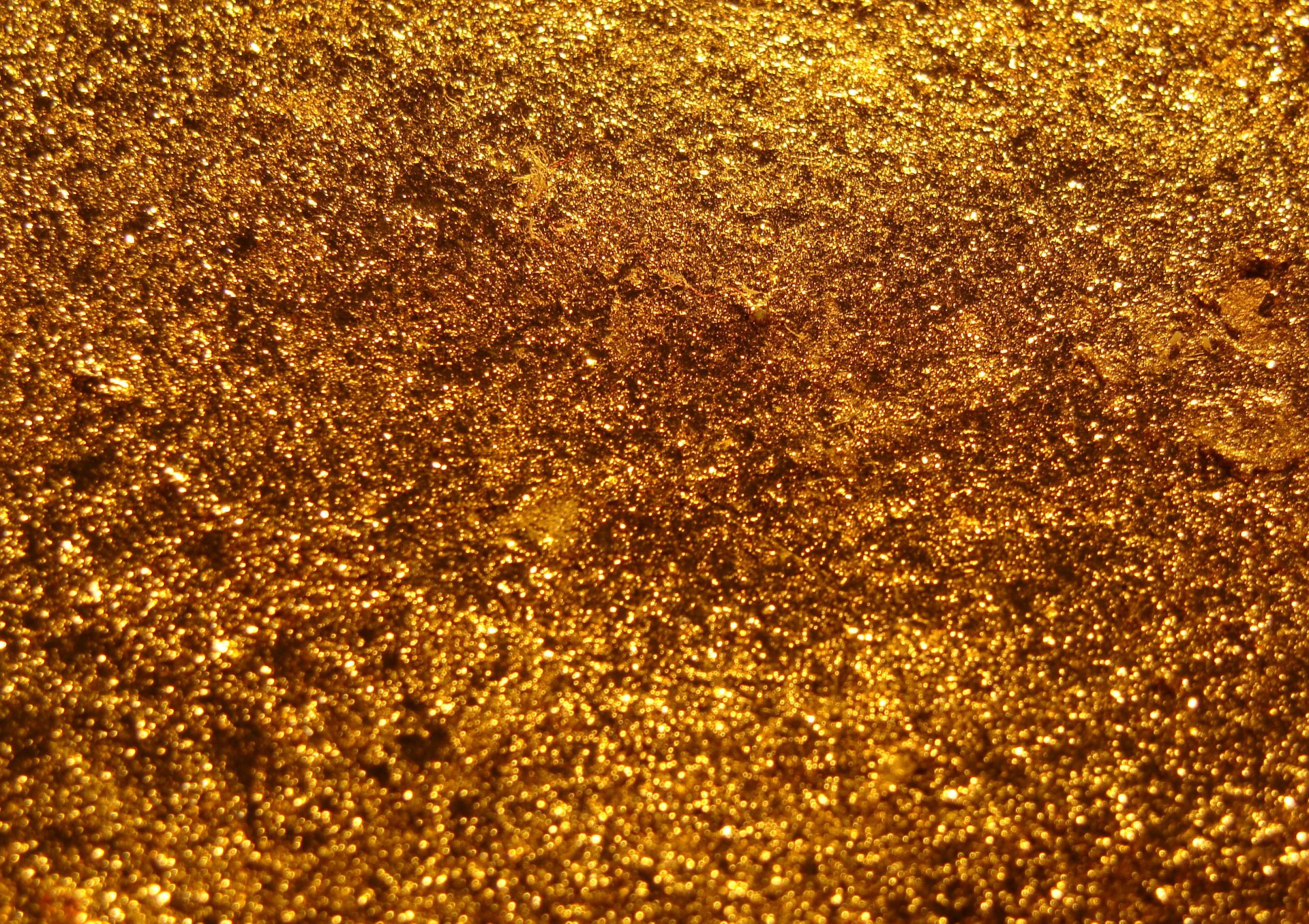 HD abstract metal texture in rich gold tones, featuring a rough and shimmering surface for a visually striking PC desktop wallpaper and background.