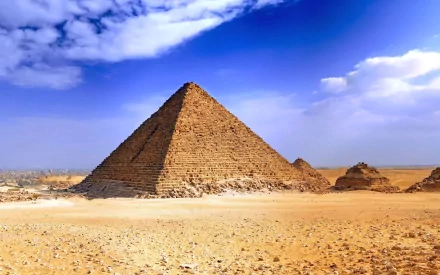 HD PC desktop wallpaper featuring a man-made Egyptian pyramid under a vibrant blue sky with scattered clouds, captured in stunning HDR detail.