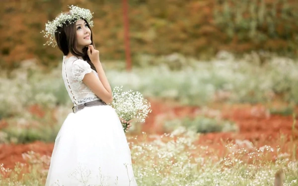 HD desktop wallpaper featuring a woman in a white dress with a flower crown, reflecting a serene mood amidst a picturesque field.