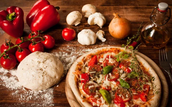 A freshly baked pizza topped with tomatoes, peppers, and herbs sits on a wooden table, surrounded by ingredients like mushrooms, garlic, and dough, creating a vibrant food scene.