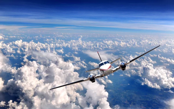 A high-definition wallpaper features an aircraft soaring through a bright blue sky, surrounded by billowing white clouds, creating an expansive and dynamic background.