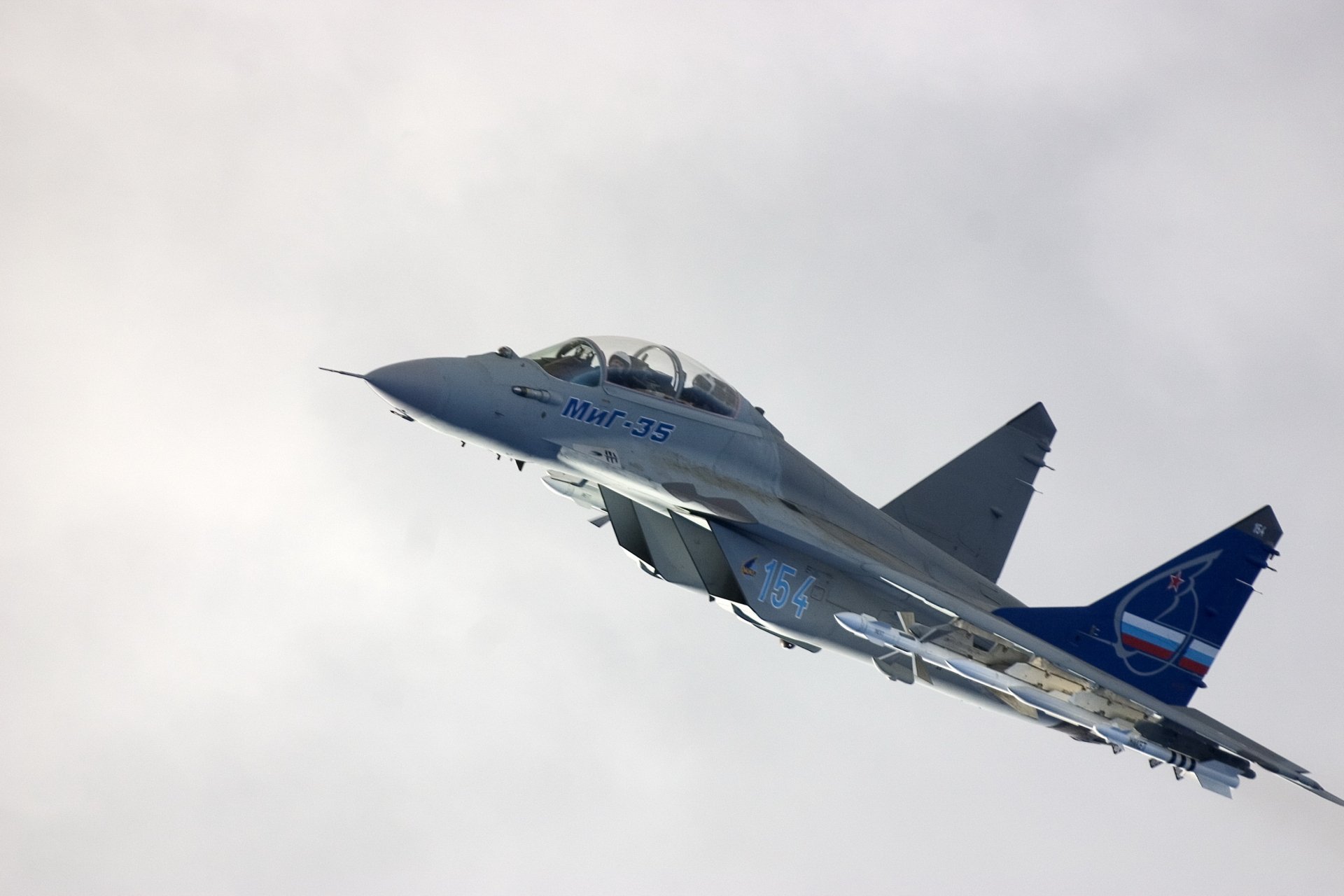 A Mikoyan MiG-35 fighter jet soars through the sky, showcasing its sleek design and military prowess in this HD desktop wallpaper and background.