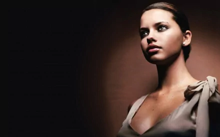 HD PC desktop wallpaper featuring a close-up portrait of celebrity Adriana Lima against a dark background.