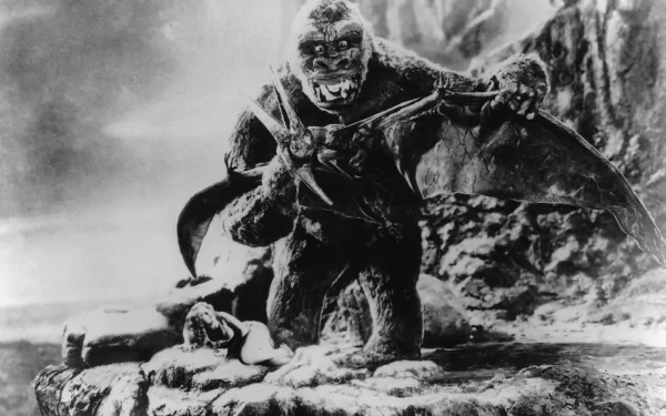 Black and white HD wallpaper featuring King Kong from the iconic 1933 movie, depicting the giant ape on a rocky ledge with dramatic scenery.