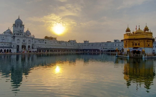 Majestic view of the Golden Temple, or Harmandir Sahib, reflecting in the serene waters at sunset, showcasing its beauty as a significant religious Gurudwara.