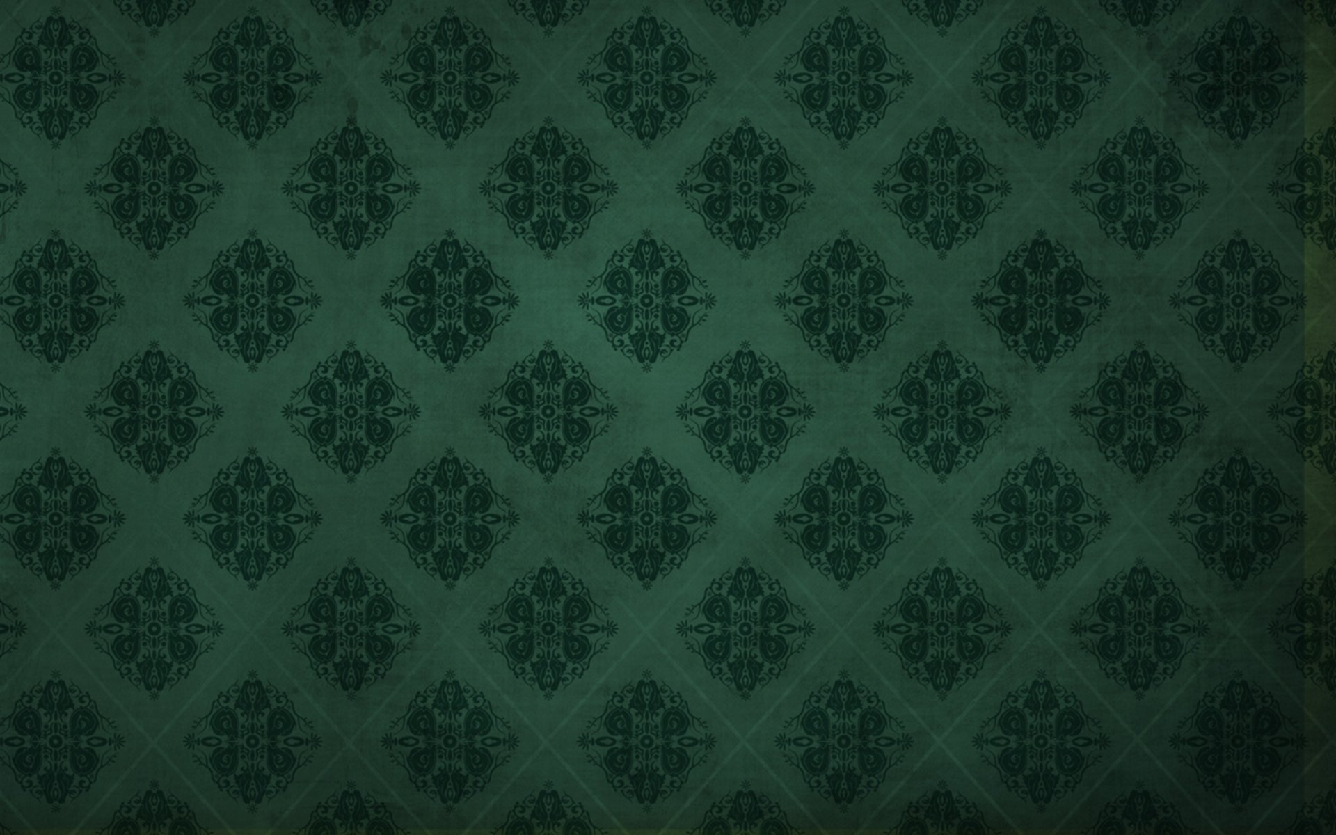 Abstract dark green pattern with intricate shapes arranged in a repeating diamond grid, designed as an HD PC desktop wallpaper background.