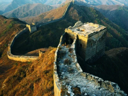 HD desktop wallpaper showcasing the man-made Great Wall of China winding over the mountainous landscape at sunset.