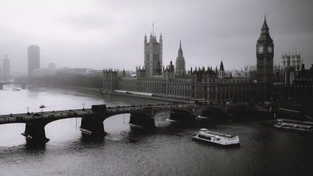 A misty view of London featuring the iconic Big Ben and the Houses of Parliament, captured from a bridge over the River Thames, creating a stunning desktop wallpaper.