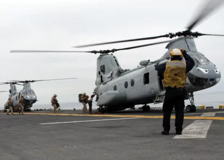 Marines and Navy personnel boarding Boeing Vertol CH-46 Sea Knight military helicopters on a deck, captured in this HD desktop wallpaper and background.