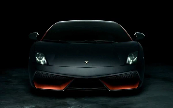 A striking black Lamborghini Gallardo with bold orange accents, showcased against a dark backdrop, makes for an eye-catching HD desktop wallpaper and background.