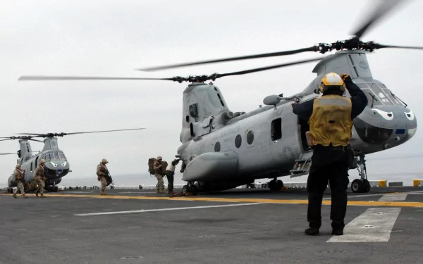 Marines and Navy personnel boarding Boeing Vertol CH-46 Sea Knight military helicopters on a deck, captured in this HD desktop wallpaper and background.