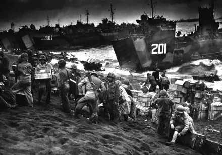 2K Quad HD PC desktop wallpaper: black-and-white WWII Battle of Iwo Jima landing, troops unloading supplies from landing craft onto a smoke-darkened volcanic beach.