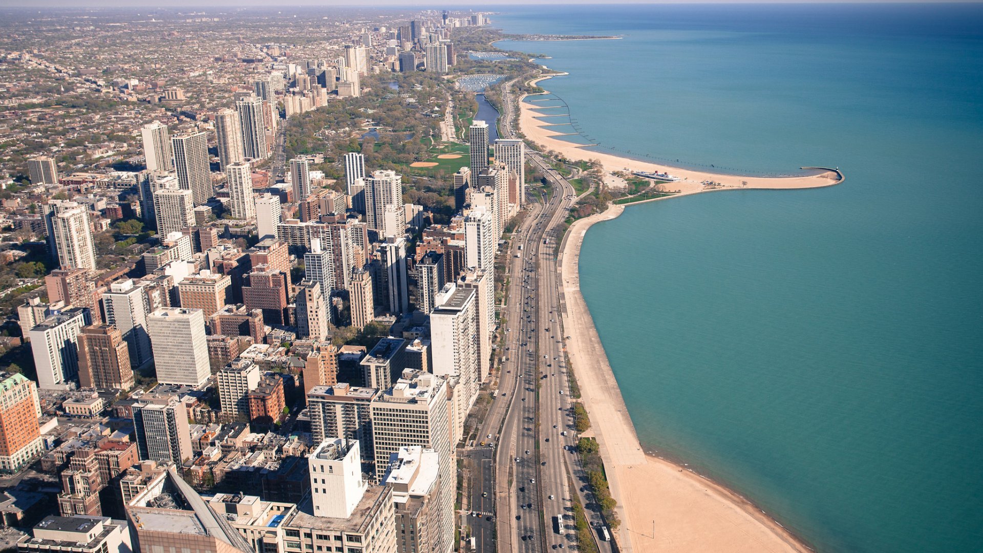 Aerial view of Chicago’s skyline along Lake Michigan shoreline in Illinois, showcasing the city’s man-made urban landscape and beaches.