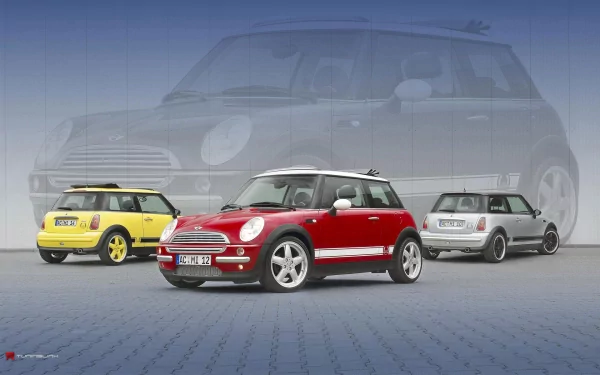 Three Mini Cooper vehicles in vibrant colors, including a red, yellow, and silver model, showcased against a subtle blue background. An eye-catching HD desktop wallpaper.