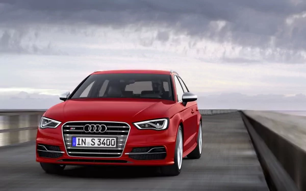 Red Audi S3 Sportback driving on a road under a cloudy sky, shown as an HD PC desktop wallpaper and background.