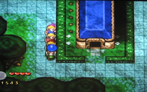 HD desktop wallpaper from The Legend of Zelda: Four Swords Adventures featuring characters near a blue pool on a vibrant, pixelated green landscape.