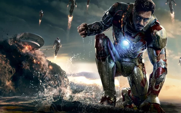 HD desktop wallpaper featuring Iron Man from the movie Iron Man 3, kneeling with an intense expression, glowing arc reactor, and multiple Iron Man suits in the background amid a dramatic, explosive scene.