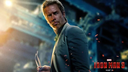 Guy Pearce in a dramatic moment from the movie Iron Man 3, set against a visually striking backdrop. HD desktop wallpaper showcasing intense cinematic elements.
