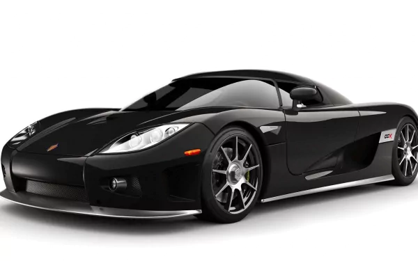 A sleek black Koenigsegg CCX showcases its aerodynamic design, highlighted against a clean background, serving as an eye-catching HD desktop wallpaper.