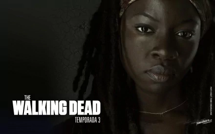 Close-up of Michonne from The Walking Dead, portraying strength and resilience. Danai Gurira shines as this iconic character in a dramatic, moody wallpaper design.