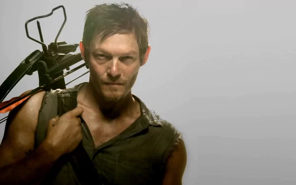 HD desktop wallpaper featuring Norman Reedus as Daryl Dixon from the TV show The Walking Dead, holding a crossbow with a determined expression against a plain background.