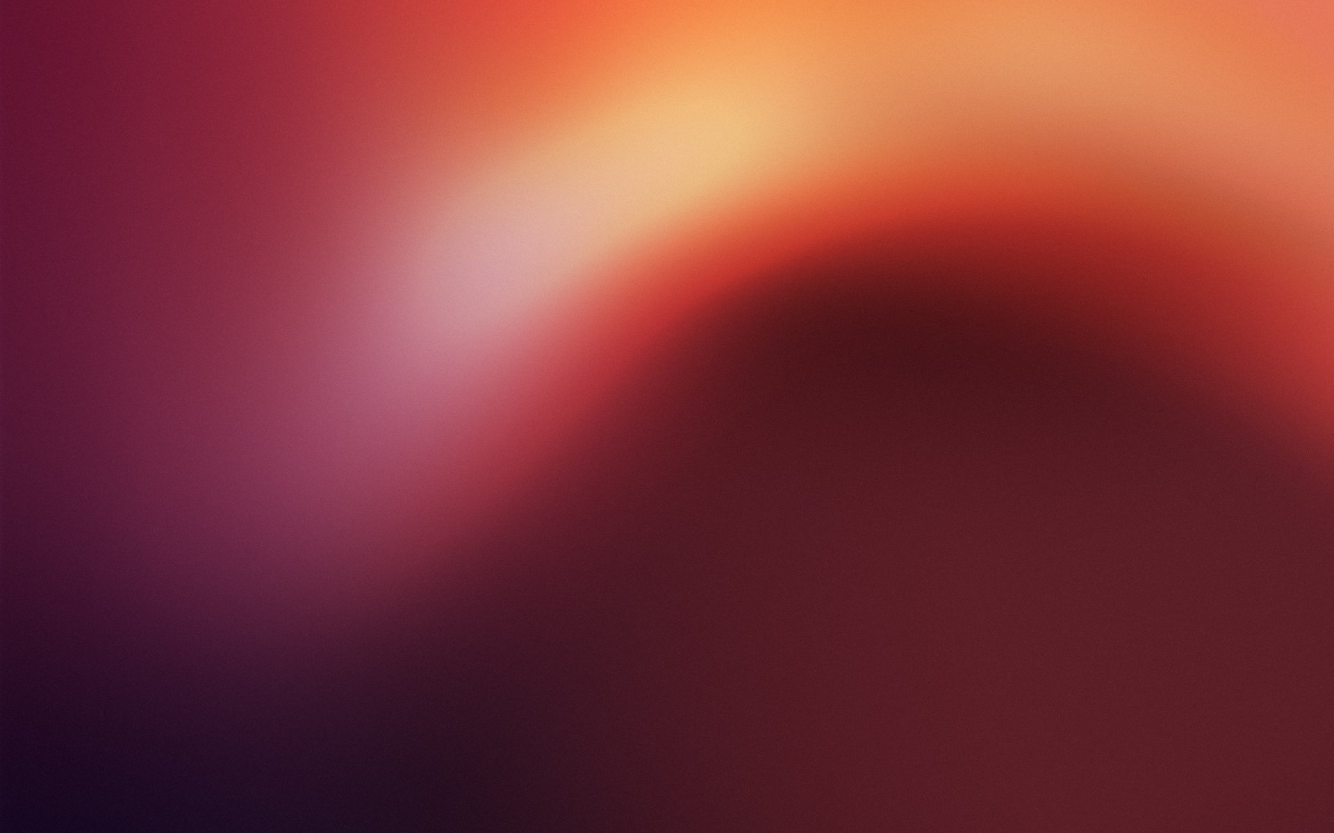 Abstract red-orange blurred gradient with a soft light sweep from crimson to amber — 2K Quad HD PC desktop wallpaper/background
