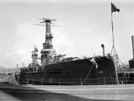 Black-and-white 4K Ultra HD image of the Argentine Navy battleship ARA Moreno docked, showcasing its military design and maritime details.